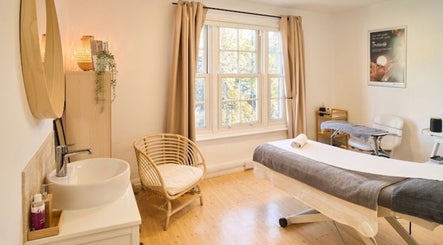 Relaxing therapy room at enhancedbychlo, Oxford, England, GB. Cozy decor and natural light create a tranquil setting.