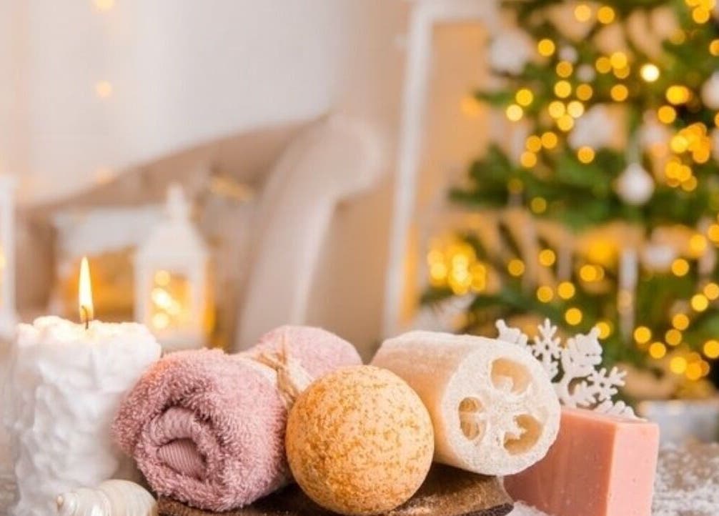 Relaxing spa setting at Somar Wellness Spa in Grapevine, Texas, US, with candles, towels, and Christmas decor.