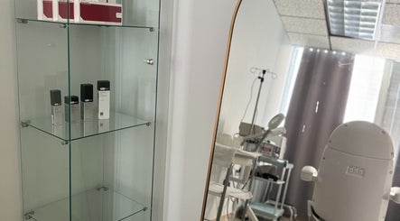 Glass shelves with skincare and a cozy treatment chair at Northshore Health and Beauty, Skokie, Illinois, US.