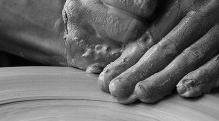Close-up of hands working clay at The Aesthetic House in London, England, GB.