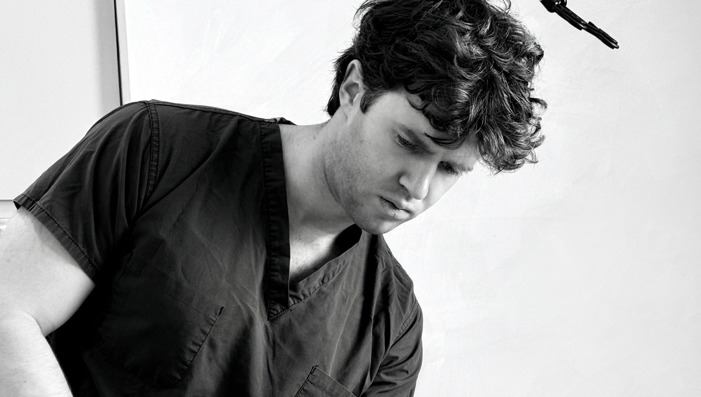 A focused professional at The Aesthetic House, London, England, GB providing top beauty treatments.