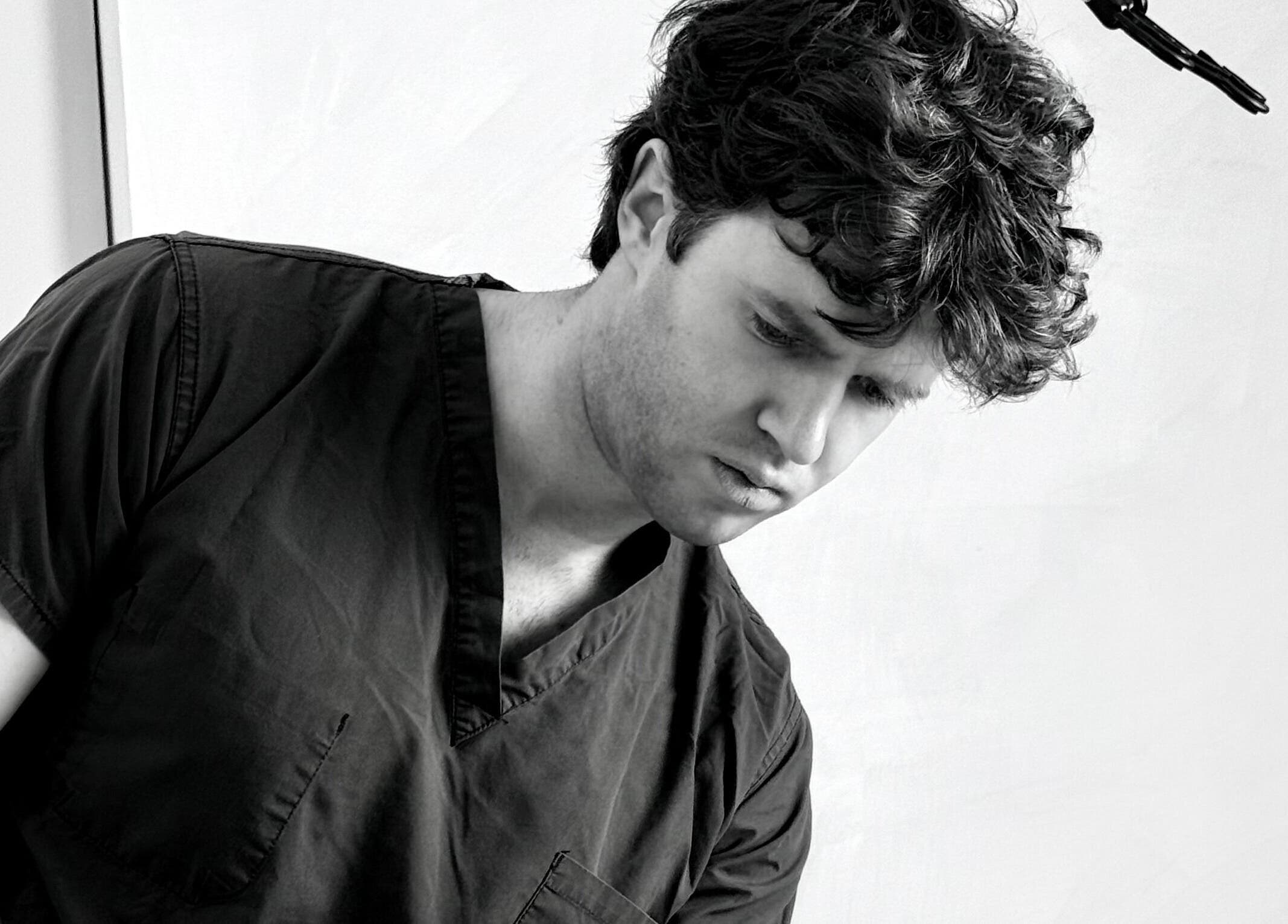 A focused professional at The Aesthetic House, London, England, GB providing top beauty treatments.