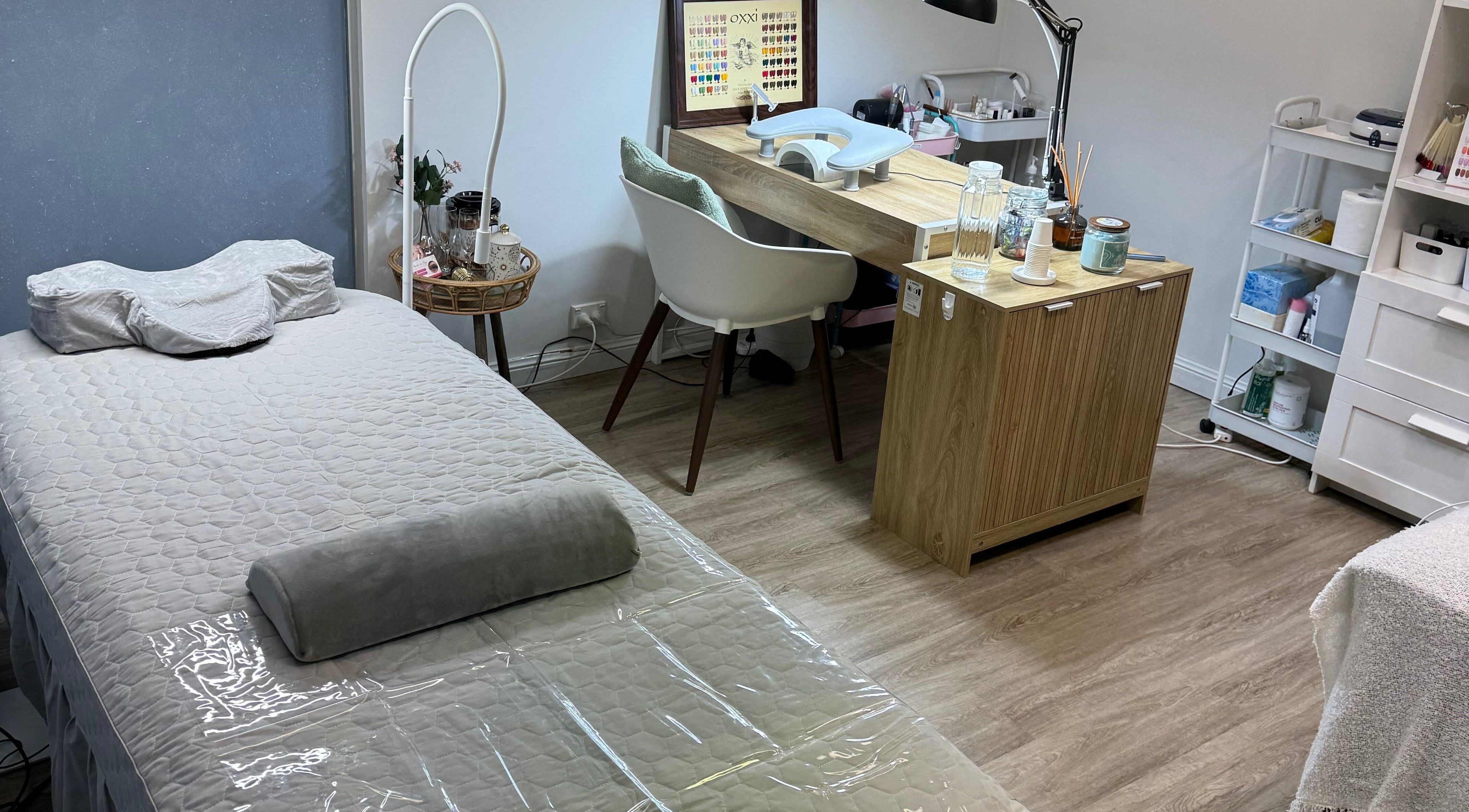 Tranquil treatment room at Beauty By Olga, Sydney, New South Wales, AU with a cozy bed and nail station.