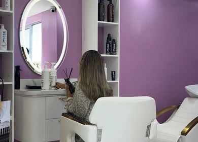 Urban Beauty salon interior in Tijuana, Baja California, MX with a stylish purple wall and chic decor.