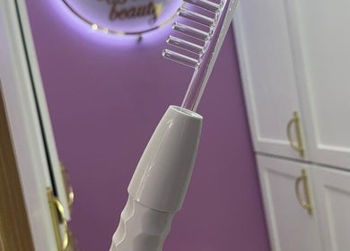 Elegant beauty tool in Urban Beauty, Tijuana, Baja California, MX, against a purple wall and white cabinets.