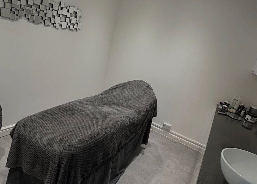 Peaceful treatment room at Beauty by Mel, Glenfield, England, GB, with a plush massage bed and modern decor.