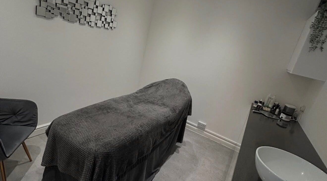 Peaceful treatment room at Beauty by Mel, Glenfield, England, GB, with a plush massage bed and modern decor.