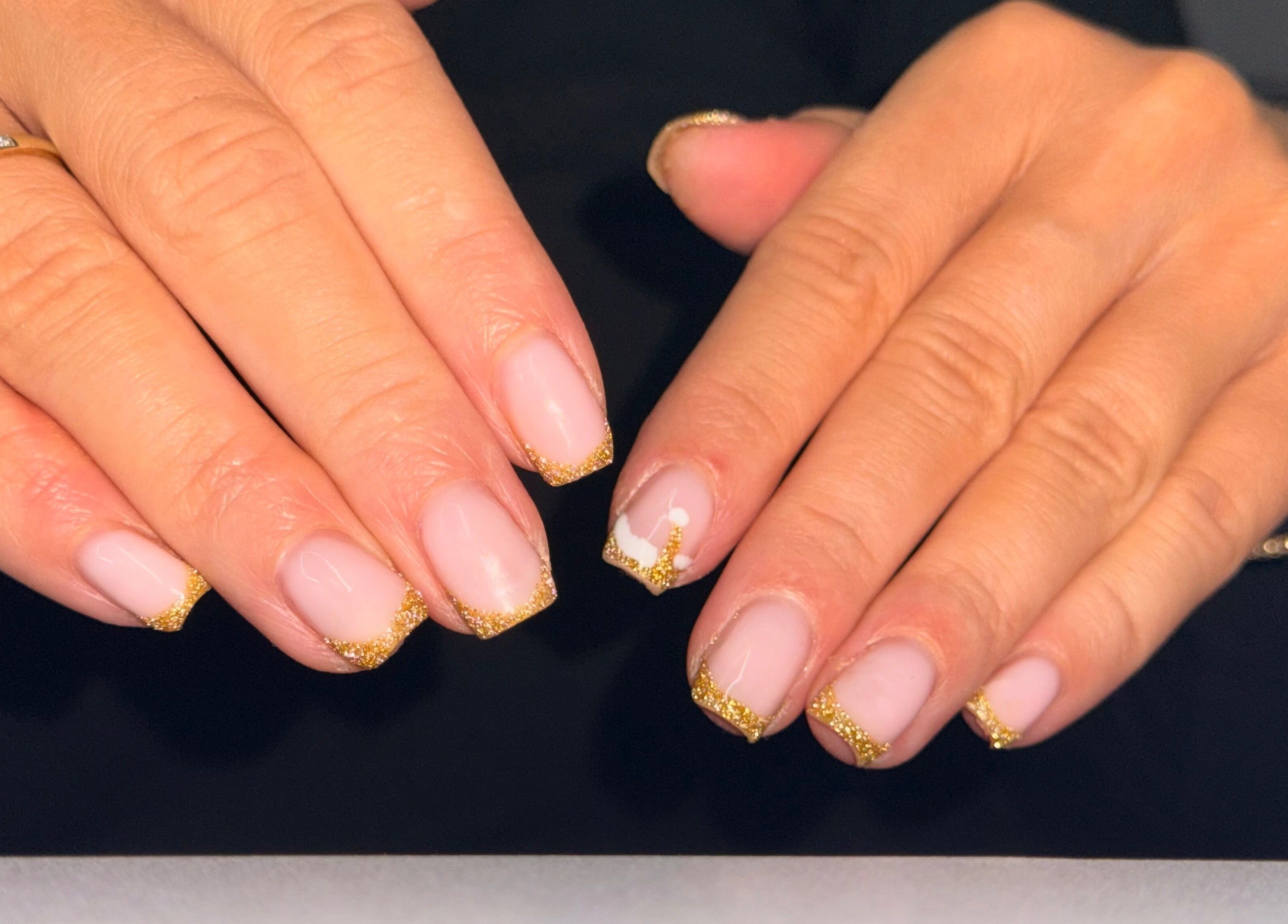 Elegant gold-tipped nails done at Beauty by Mel, Glenfield, England, GB showcasing intricate nail art.