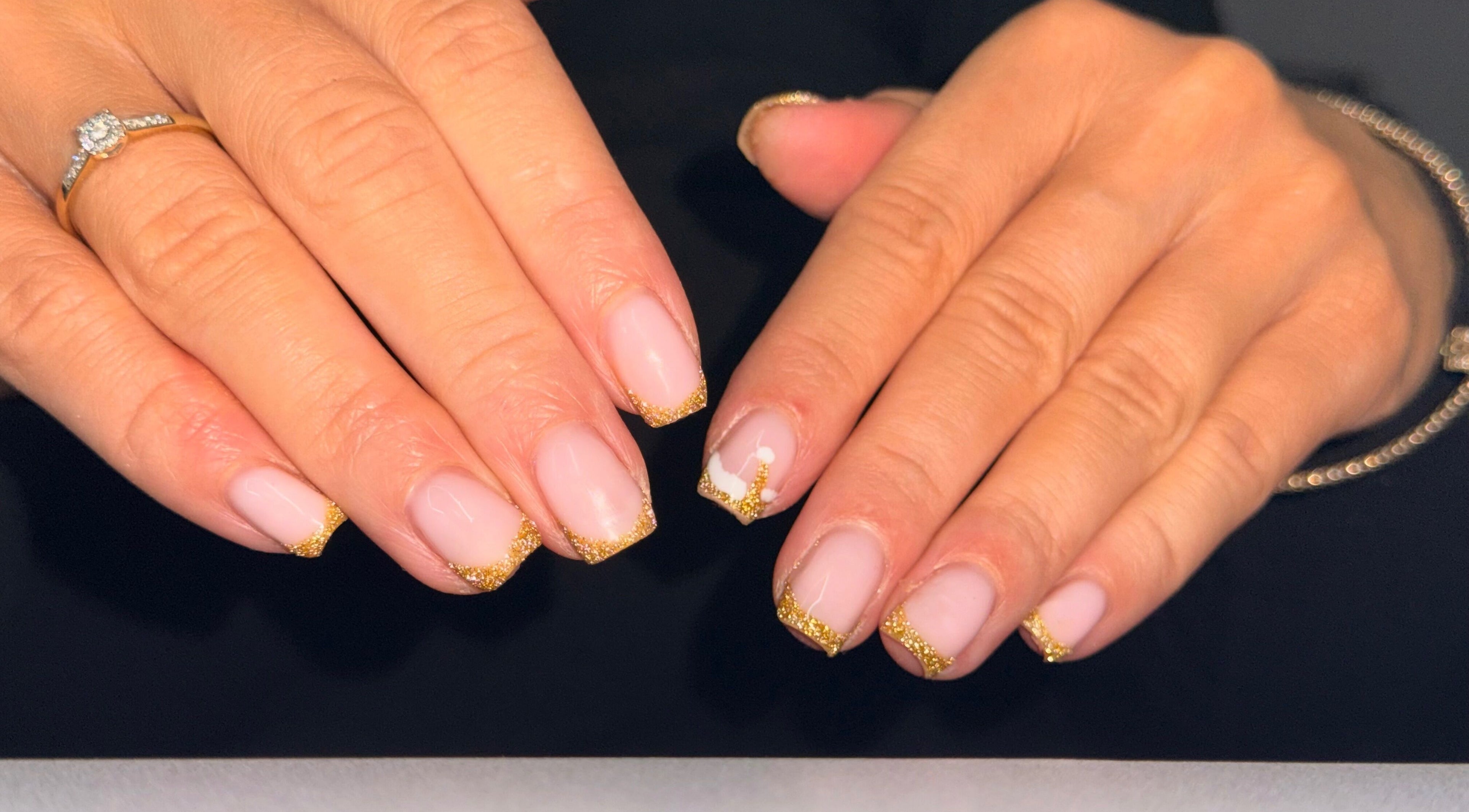 Elegant gold-tipped nails done at Beauty by Mel, Glenfield, England, GB showcasing intricate nail art.