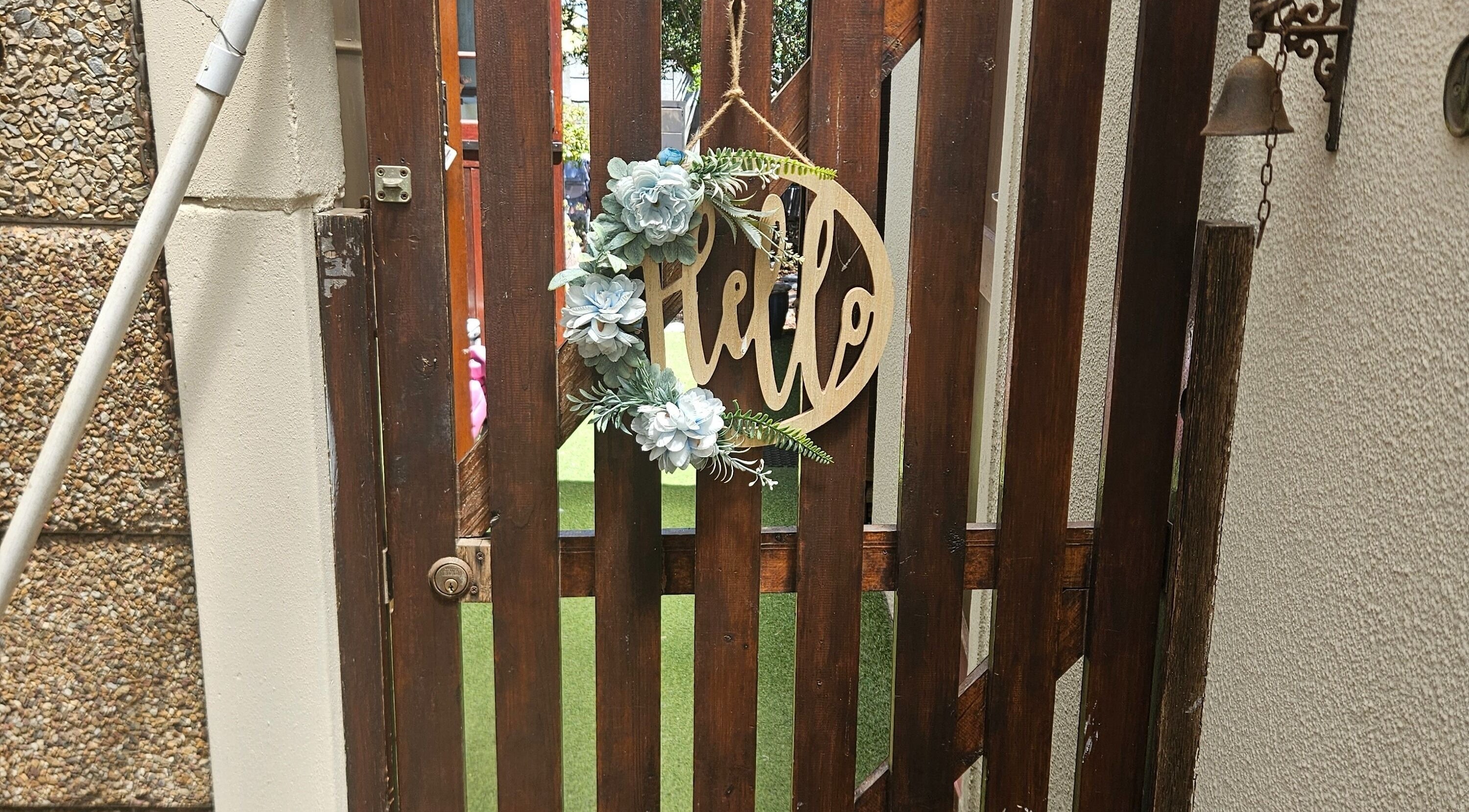 Rustic gate with 'Hello' sign at Lashed by Varuska, Cape Town, Western Cape, ZA.