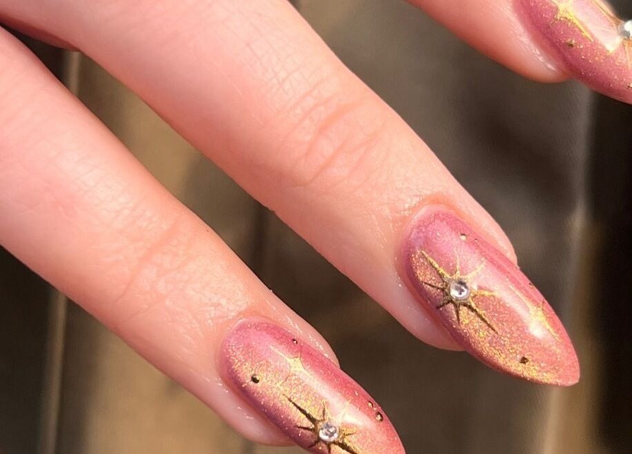 Elegant starlit nail art at Amanda Does My Nails in Edinburgh, Scotland, GB, featuring pink and gold designs.
