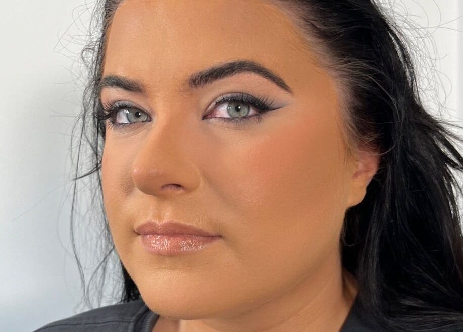 A stunning makeup look by Makeup By Naomi Jane in Ystrad Mynach, Wales, GB highlights sleek eyeliner and glowing skin.