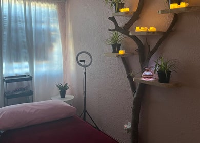 Serene therapy room at H.E.R - Heal. Embody. Rise in Cape Town, Western Cape, ZA with ambient lighting and decor.
