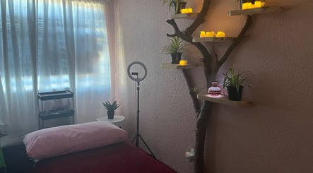 Serene therapy room at H.E.R - Heal. Embody. Rise in Cape Town, Western Cape, ZA with ambient lighting and decor.