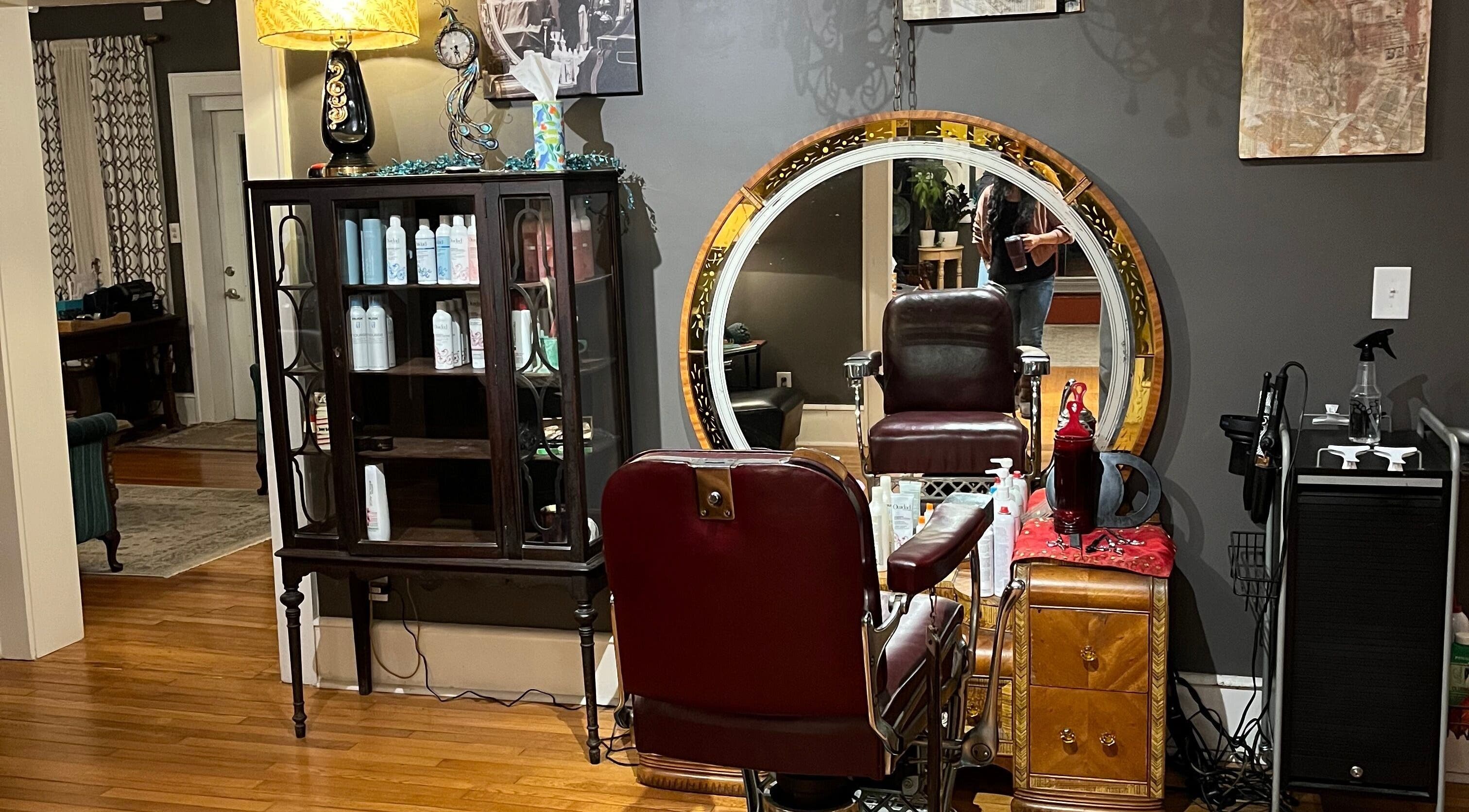 Elegant salon interior at Delta Bayer, featuring a plush chair and ornate mirror in Roanoke, Virginia, US.