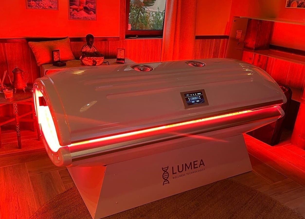 Red-lit wellness room at Hyperbaric Spa Faro, Faro, Faro, PT featuring advanced therapy equipment.