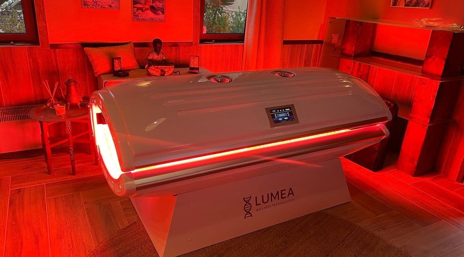 Red-lit wellness room at Hyperbaric Spa Faro, Faro, Faro, PT featuring advanced therapy equipment.