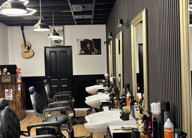 Elegant barber chairs in MOSS Salon, London, England, GB, with stylish decor and modern lighting.