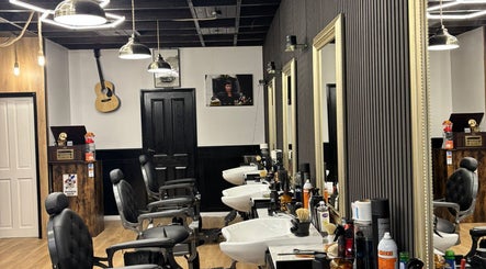 Elegant barber chairs in MOSS Salon, London, England, GB, with stylish decor and modern lighting.