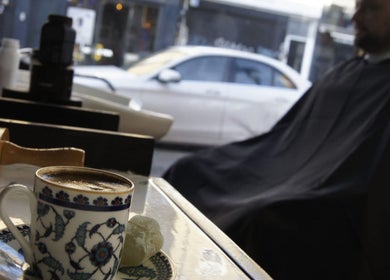 Cup of coffee and grooming tools at MOSS Salon, London, England, GB.