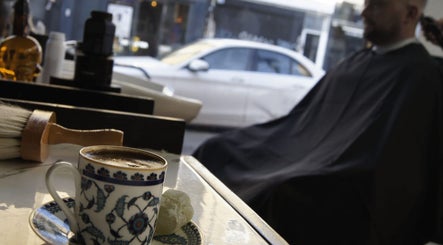 Cup of coffee and grooming tools at MOSS Salon, London, England, GB.