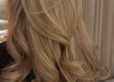 Blonde hair styled in elegant waves at Amy Rose Hair, Newcastle-under-Lyme, England, GB.