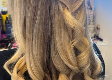Blonde hair styled in elegant curls at Amy Rose Hair, Newcastle-under-Lyme, England, GB.