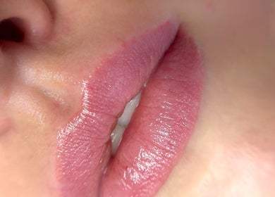 Close-up of glossy lips at Juste Vaiciene in Peterborough, England, GB offering beauty treatments.