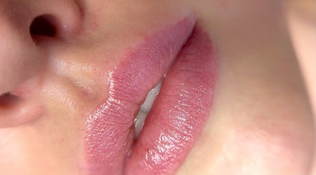 Close-up of glossy lips at Juste Vaiciene in Peterborough, England, GB offering beauty treatments.