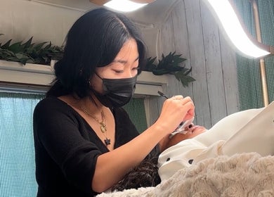 Lash Ark technician performs eyelash extension in Worcester Park, England, GB for a client.