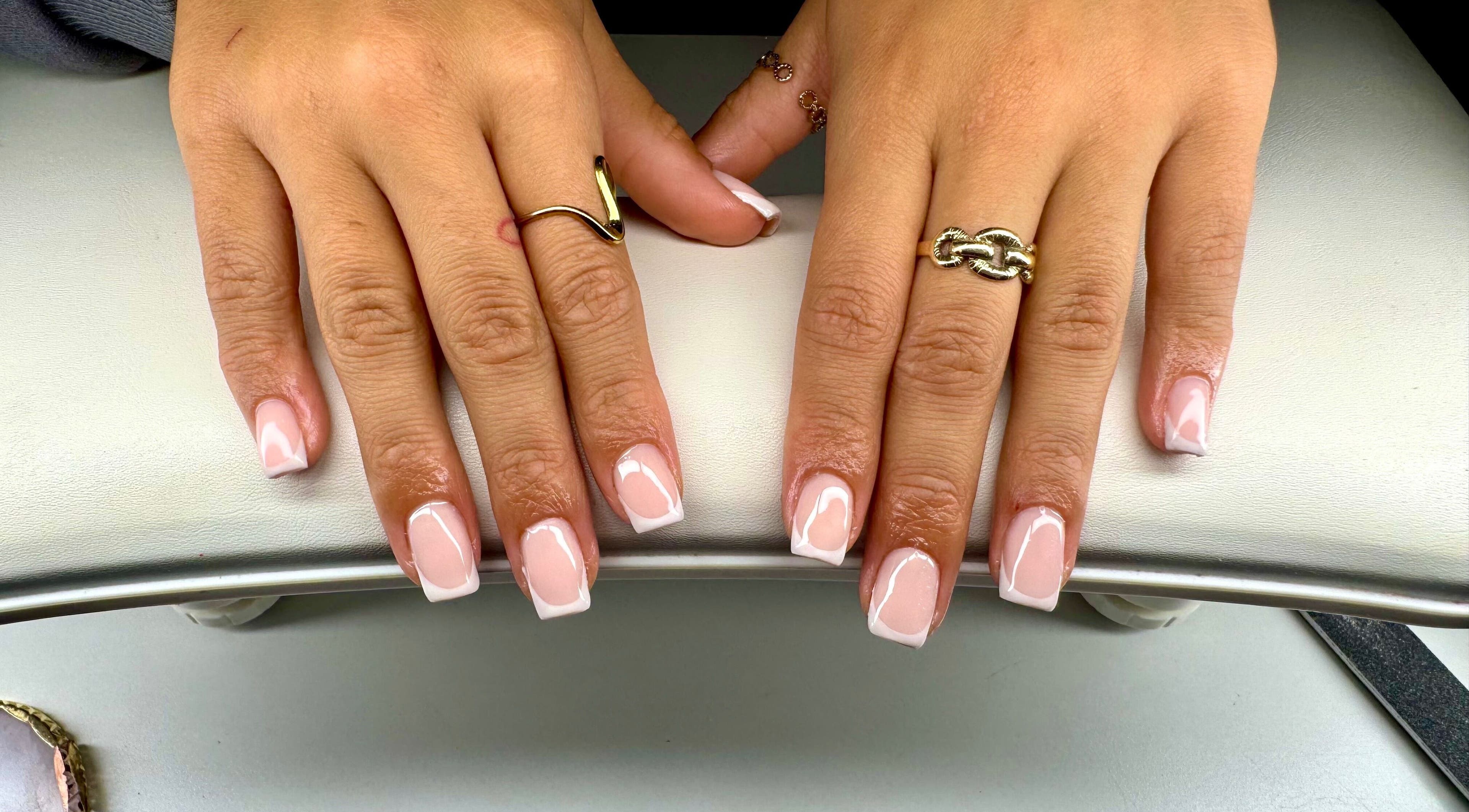 Elegant French manicure at Coated by EJ, Croydon, England, GB. Stylish nail art and beauty.