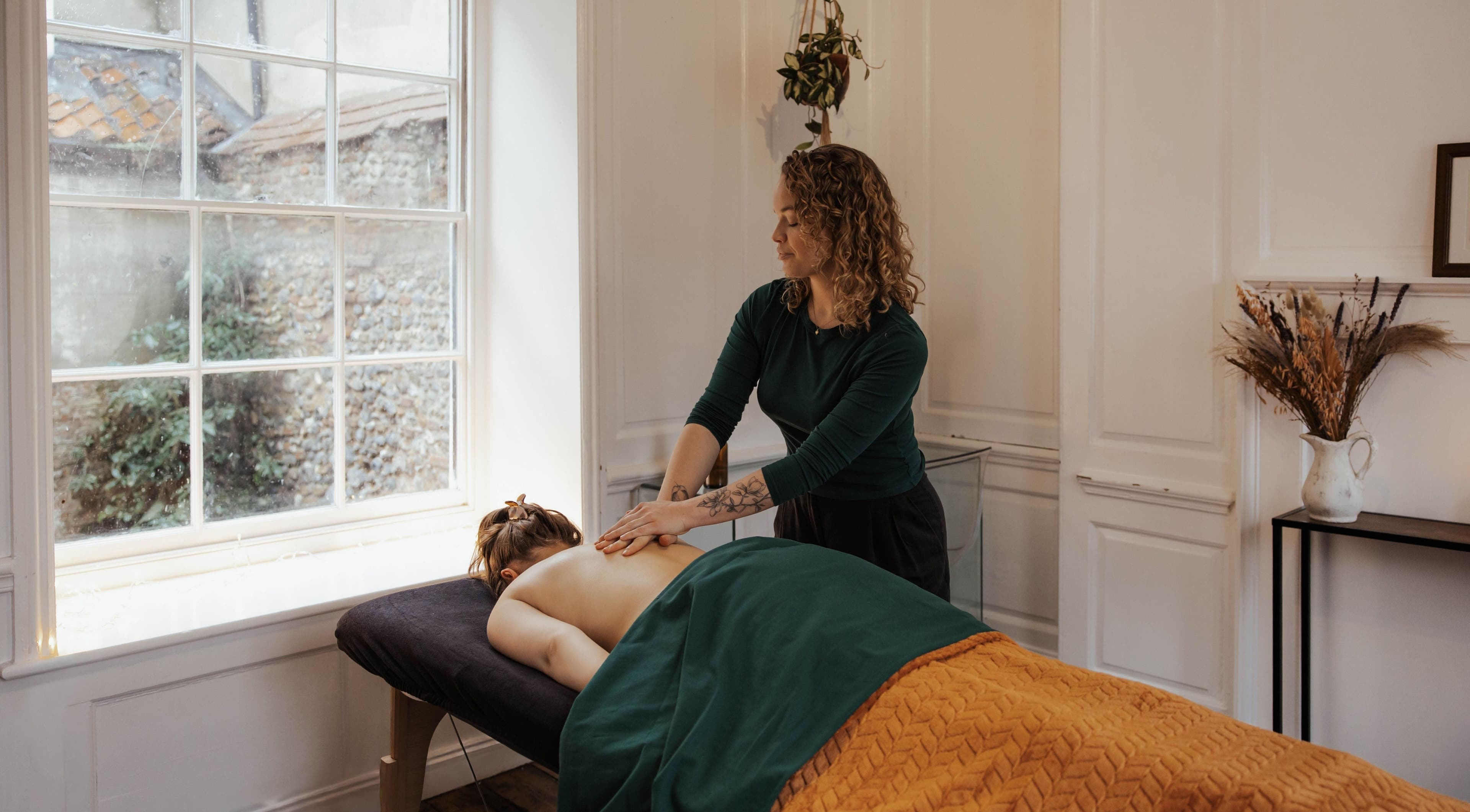 Massage therapy session at The Elsewhere in Norwich, England, GB, highlighting relaxation and wellness.