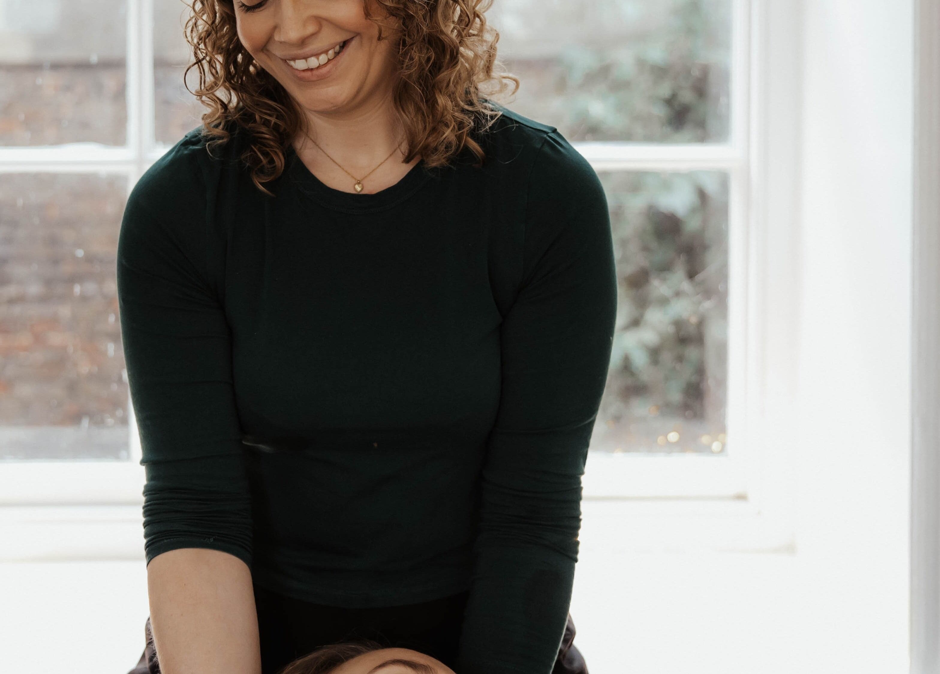 Therapist at The Elsewhere in Norwich, England, GB provides a relaxing massage session.