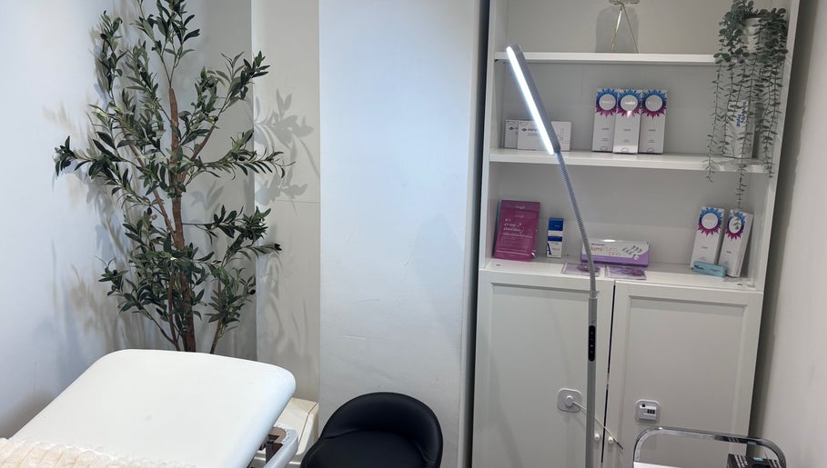 Relaxing treatment room at Lumora Aesthetics, London, England, GB, featuring a plush bed and elegant decor.