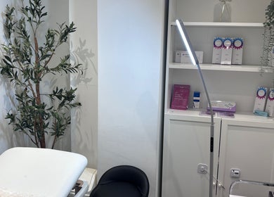 Relaxing treatment room at Lumora Aesthetics, London, England, GB, featuring a plush bed and elegant decor.