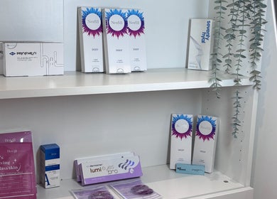 Beauty products on shelf at Lumora Aesthetics, London, England, GB showcasing skincare items.