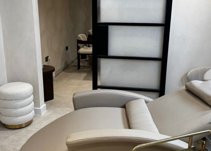 Tranquil treatment room at ELLUMÉ SKIN @ TONES HEMEL, Hemel Hempstead, England, GB, showcasing a plush chair.