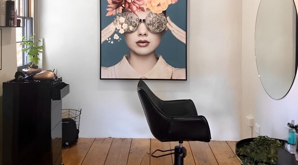 Elegant salon chair at ADORE HAIR BODY BEAUTY, Willaston, South Australia, featuring chic decor and modern art.