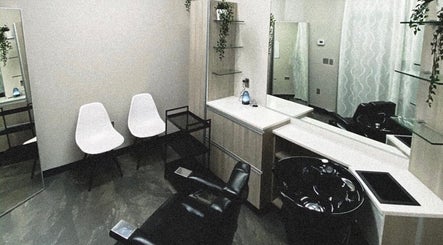 Modern salon space at Enigma, Redwood City, California, US with sleek chairs and decor.
