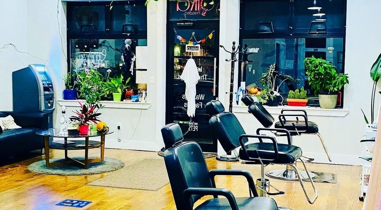 Interior of Sika Threading Salon in New York, New York, US, showcasing stylish seating and décor.