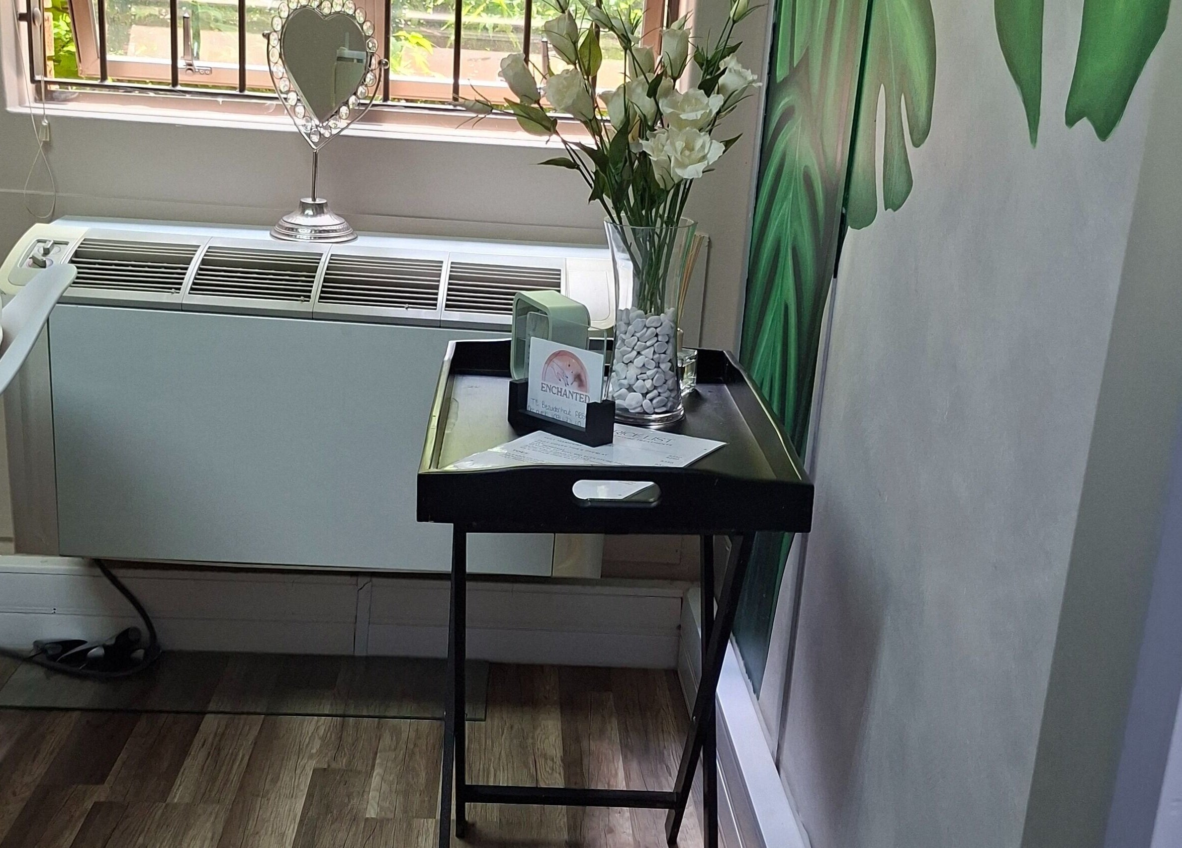 Stylish decor at Enchanted Nails by Tania in Pretoria, Gauteng, ZA, featuring floral elements and a heart mirror.