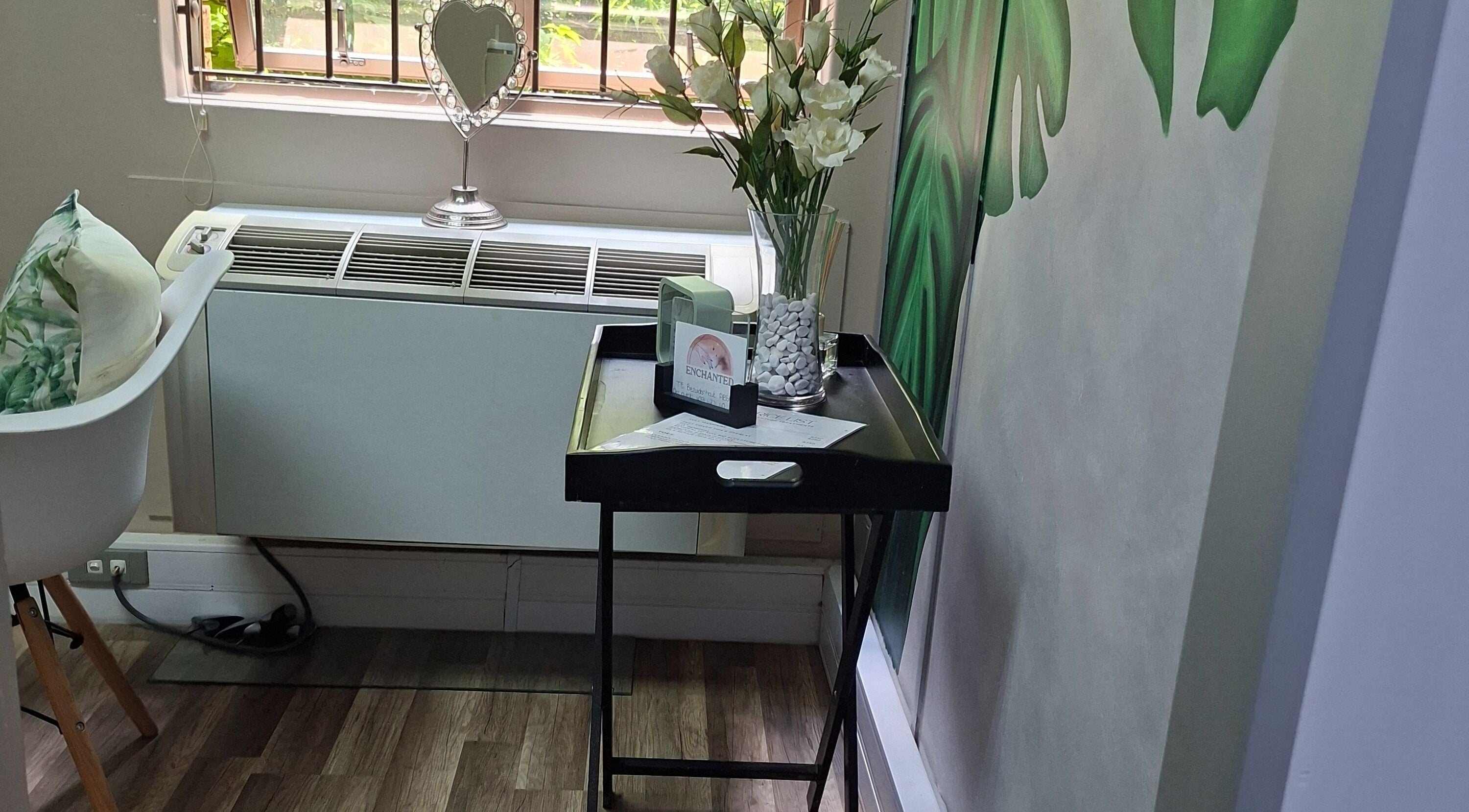 Stylish decor at Enchanted Nails by Tania in Pretoria, Gauteng, ZA, featuring floral elements and a heart mirror.