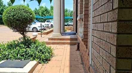 Brick pathway and lush greenery at Enchanted Nails by Tania, Pretoria, Gauteng, ZA.