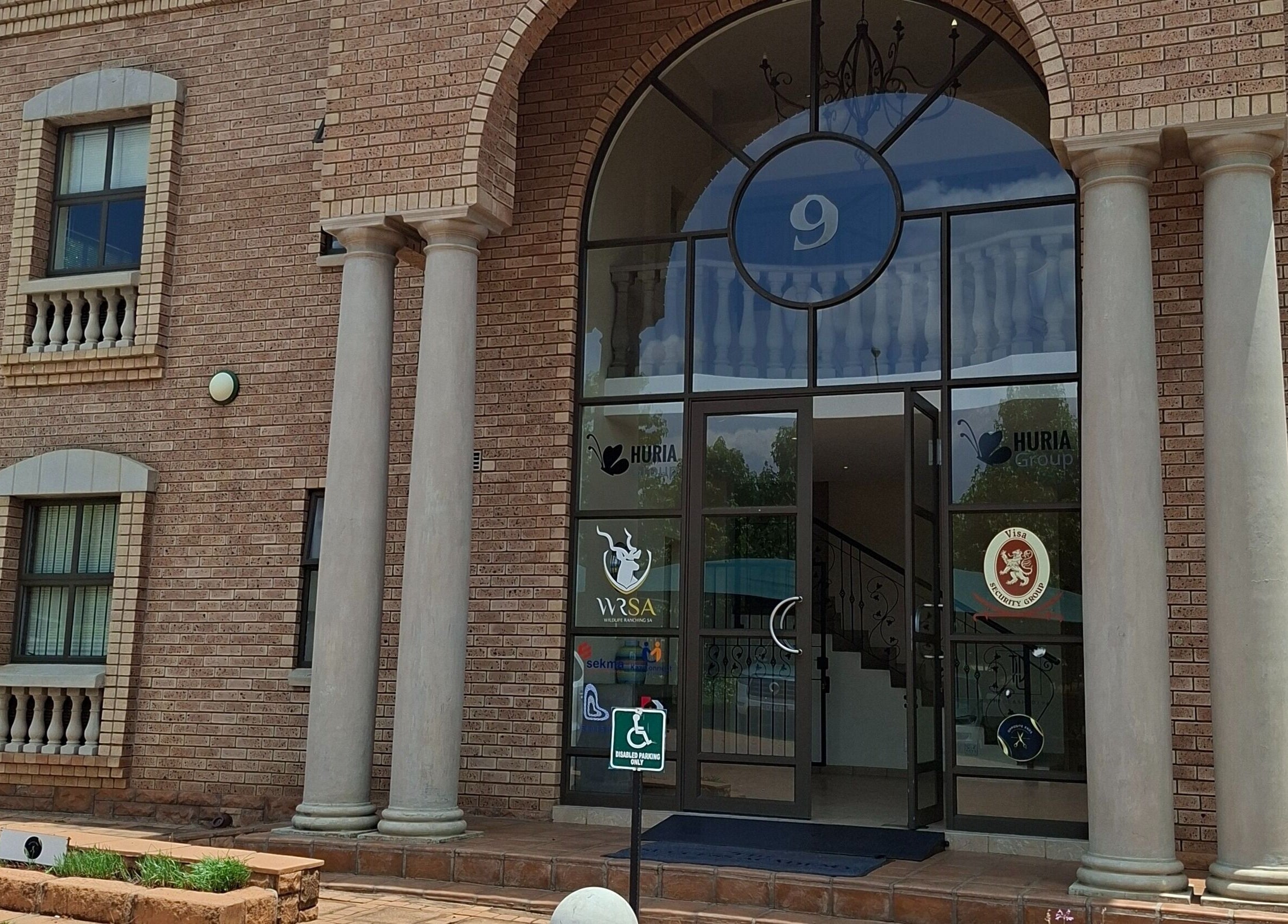 Elegant entrance to Enchanted Nails by Tania, Pretoria, Gauteng, ZA, showcasing grand pillars.