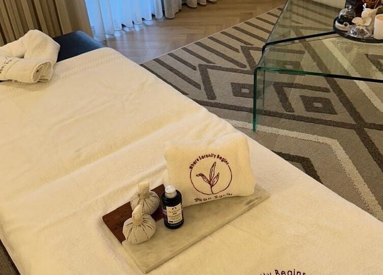 Relaxing spa setup at Baan Sabai, Riyadh, featuring plush towels and soothing oils for ultimate wellness.