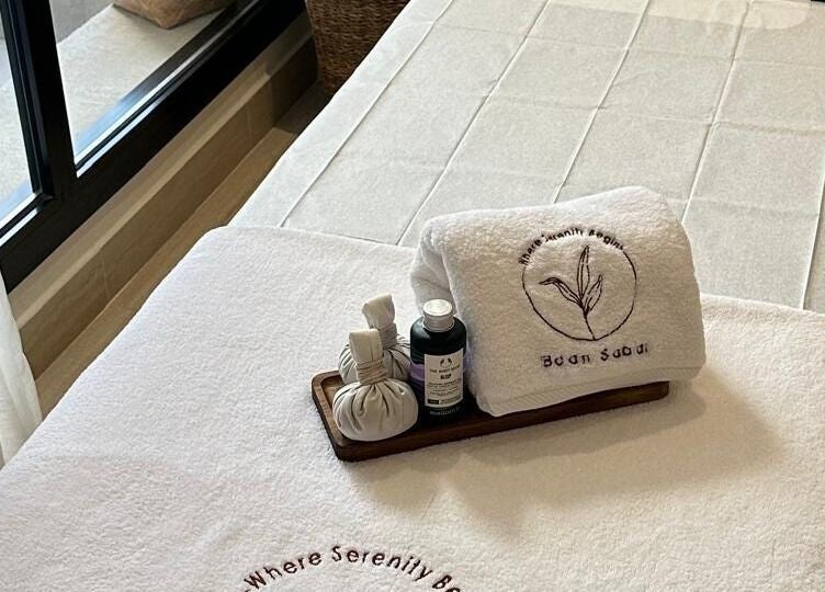 Luxurious treatment bed at Baan Sabai, Riyadh, Riyadh Province, SA, with towels and spa essentials.