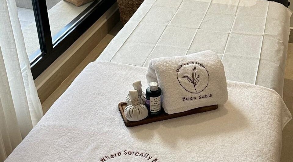 Luxurious treatment bed at Baan Sabai, Riyadh, Riyadh Province, SA, with towels and spa essentials.
