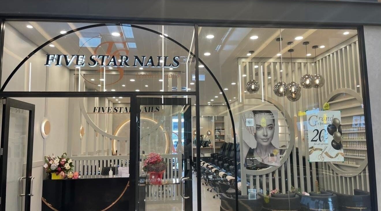 Front of Five Star Nails Aesthetic Ormiston, Auckland, NZ with open glass door and stylish interior visible.
