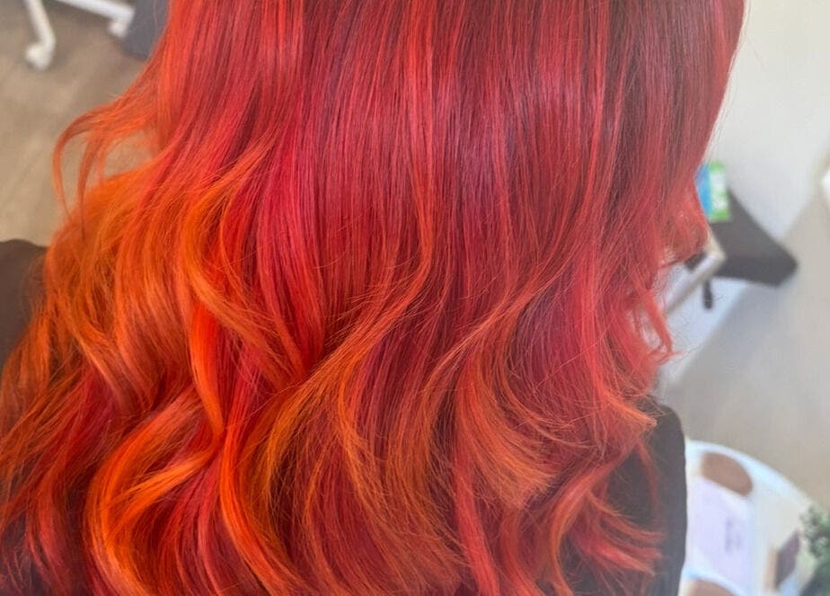 Vibrant red-orange hair styling at Hair by Sandra, Falkirk, Scotland, GB. Perfect color transformation!