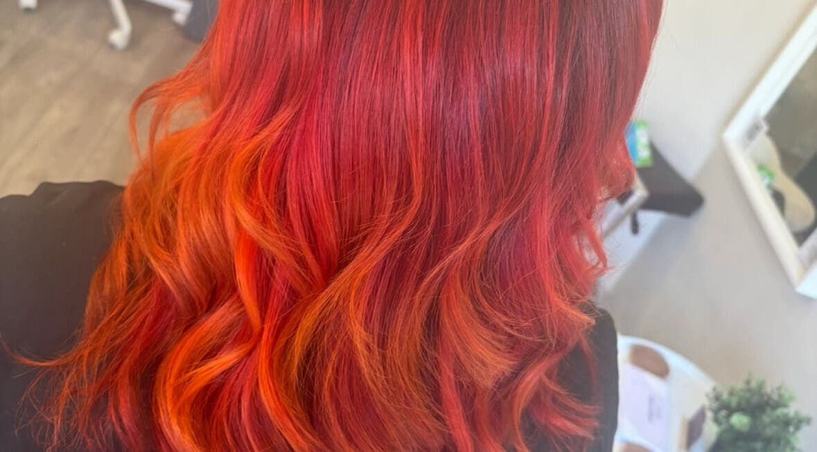 Vibrant red-orange hair styling at Hair by Sandra, Falkirk, Scotland, GB. Perfect color transformation!